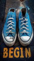 A pair of worn blue sneakers with scuff marks on the soles, symbolizing a new journey with the word 'BEGIN' beneath. photo