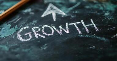 A chalkboard displaying the word 'Growth' with an upward arrow, symbolizing progress and development. photo