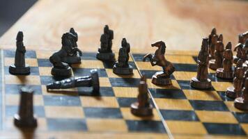 Strategic Battle on the Chessboard The chess pieces stand poised on the board, ready for a game of strategy and intellect. photo