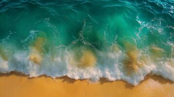 Crystal clear turquoise waves gently crashing on a sandy beach. photo