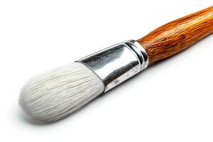 Close-up of a paintbrush with a wooden handle and soft bristles, ideal for artists and creative projects. photo
