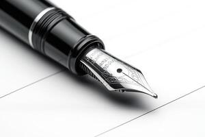 A close-up of a sleek black fountain pen with an ornate silver nib, resting on a white lined paper. photo