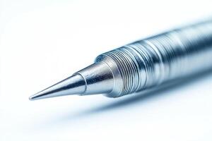 Close-up of a sleek metallic ballpoint pen with a finely pointed tip, showcasing modern design and craftsmanship. photo