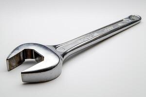 Close-up of a shiny metal adjustable wrench on a light background, symbolizing tools and craftsmanship. photo
