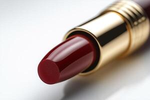 Close-up of a luxurious red lipstick with a golden casing, showcasing its creamy texture and bold color. photo