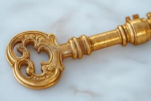 An ornate golden key resting on a marble surface, reflecting elegance and vintage charm. photo