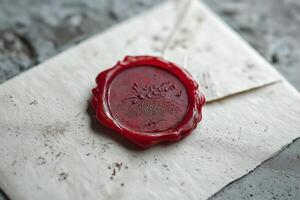A close-up of a vintage envelope sealed with a red wax seal, evoking a sense of nostalgia and elegance. photo