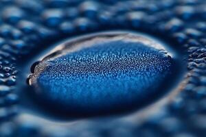 A close-up shot of a water droplet on a blue surface, showcasing a mesmerizing array of tiny bubbles. photo