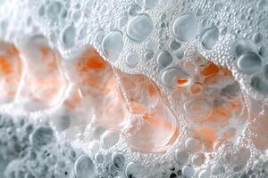 Close-up of shimmering soap bubbles with orange reflections, creating a dynamic and colorful abstract image. photo