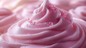 A close-up of creamy pink frosting adorned with glistening droplets, showcasing a delightful, sweet-themed dessert. photo
