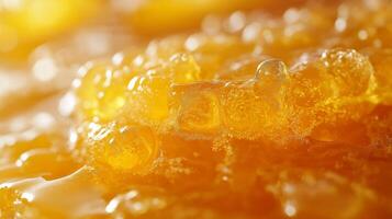 Close-up shot of golden, viscous honey dripping with a glossy sheen. photo