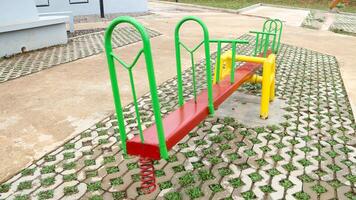The classic seesaw consists of a long board mounted on a pivot point in the center. photo