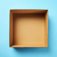 An empty cardboard box on a blue background photo