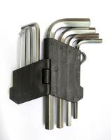 Highangle closeup of a set of Lshaped Allen keys neatly organized in a black plastic holder against a white background. photo