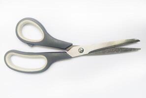 Closeup of grayhandled scissors against a white background. A simple yet versatile image representing cutting, precision, and efficiency. photo