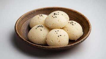 Serving of traditional rava idli from India with a soft texture and mild flavors captured in a modern high resolution minimalist gourmet food photography style photo