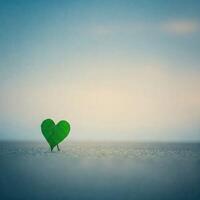 Heart-shaped sprout in sand, serene sky photo
