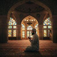 Muslim man praying in a mosque photo