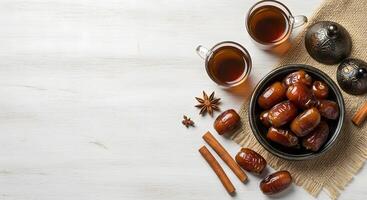 Flat lay of dates with cinnamon sticks on white background photo
