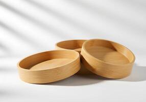 Stack of Empty Bamboo Bowls on White Surface with Window Shadows photo