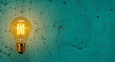 A light bulb is on a wall with a green background photo