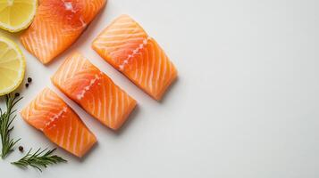 Fresh salmon slices with lemon and rosemary on white background photo