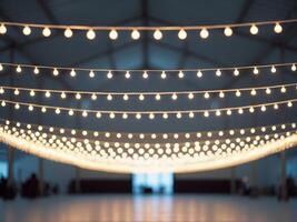 Large open space high ceiling string lights hanging Blurred background of party. photo