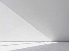 An empty room with a white wall and a light coming in photo