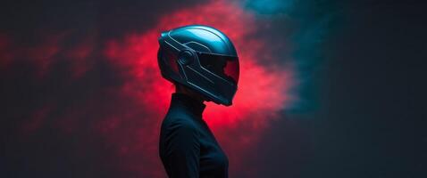 A person wearing a futuristic helmet under dramatic red and blue lighting. photo
