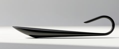 A black object with a handle and a curved end. photo