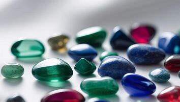 Close Up of Smooth Tumbled Gemstones in Various Shapes and Rich Jewel Tones. photo