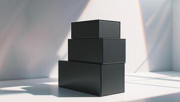 A stack of black boxes sitting on a white surface photo