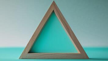 Wooden Triangle Frame on Teal Background photo