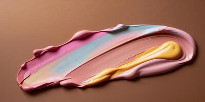 A smear of cosmetics with various color tones on a brown background. photo