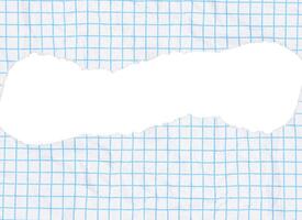 Piece of paper with a light blue grid pattern and a large, torn hole in the center. The paper has a slightly crumpled texture, torn edges are ragged. photo