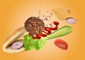 Burger with its ingredients floating in mid air against a yellow background. Ingredients include a bun, patty, lettuce, tomato, cucumber, onion, cheese, ketchup, and spices photo