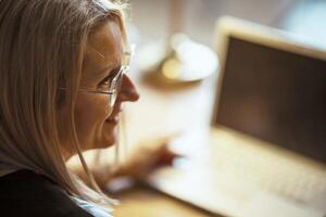 woman Calculating Success, Hands-on Strategies for Office Productivity Amidst Diagrams photo