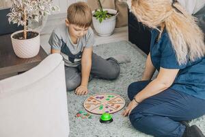 Child participating in therapy session with a professional using hands-on learning approach, focusing on social and cognitive development, concept of special education photo