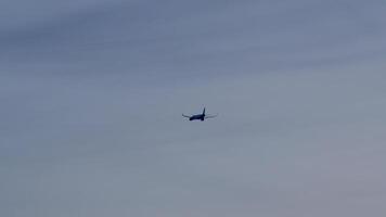 Powerful jet airliner climbing through cloudy sky, gaining dramatic altitude and soaring across expansive aerial landscape during daytime flight video