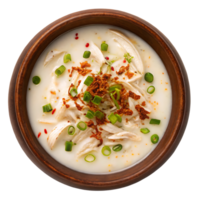 Creamy chicken soup in a rustic bowl, garnished with green onions and crispy fried onions. png