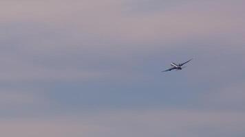 Passenger jet climbing skyward through cloud laden atmosphere, ascending after departure from airport runway with powerful engines propelling forward momentum video
