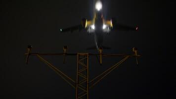 Navigational approach lighting system guiding large passenger aircraft during precise nighttime landing, illuminating runway with bright safety beacons for secure descent video