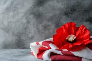 Red poppy on folded american and polish flags with vivid details and dynamic elements photo