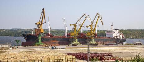 Panoramic view of a large ship loading grain for export. Water transport photo
