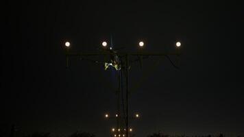 Sophisticated approach lighting system illuminating runway path for passenger airplane descending during nighttime airport landing sequence, guiding aircraft with precise navigational beams video