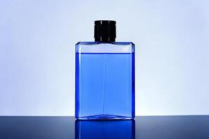 A blue bottle of perfume sitting on a table photo