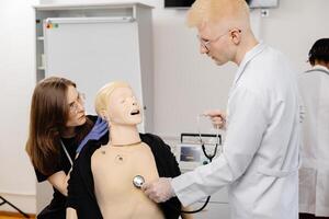 Medical Students Practicing on Anatomical Model with Stethoscope photo