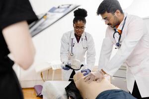 Doctors practicing cardiopulmonary resuscitation on manikin. photo