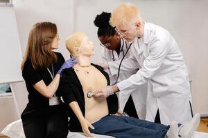Medical Students Practicing Endotracheal Intubation on a Medical Mannequin photo