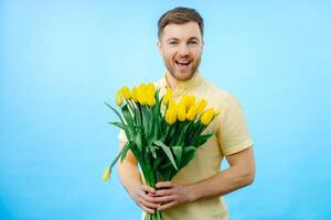 Man is holding bouquet of flowers in front of face photo
